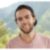 outdoor-shot-young-caucasian-man-with-beard-relaxing-open-air-surrounded-by-beautiful-mountain-setting-rainforest 1